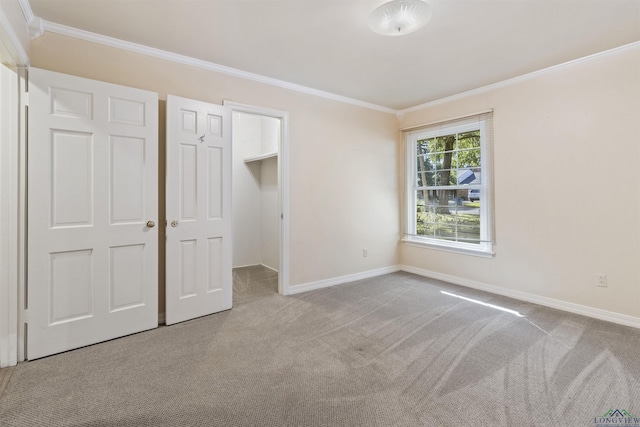 unfurnished bedroom with crown molding and light colored carpet