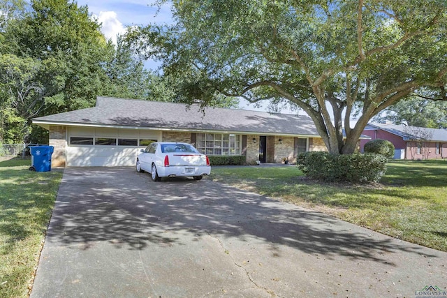 ranch-style house featuring a garage and a front yard