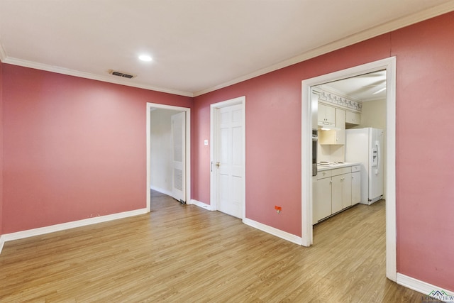 unfurnished room with light hardwood / wood-style flooring and crown molding