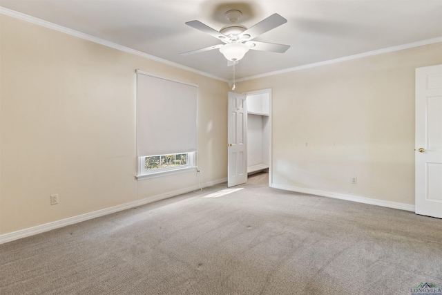 carpeted empty room featuring ceiling fan and ornamental molding