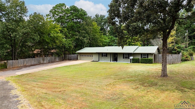 ranch-style house featuring a garage and a front lawn