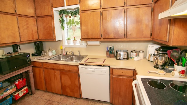 kitchen featuring sink, white dishwasher, light tile patterned flooring, and stove