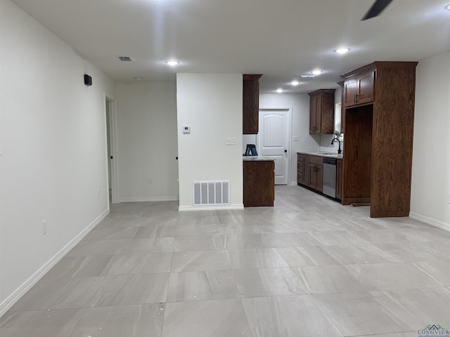 kitchen with sink, dark brown cabinets, and stainless steel dishwasher