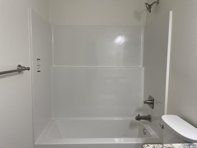 bathroom with shower / washtub combination and toilet