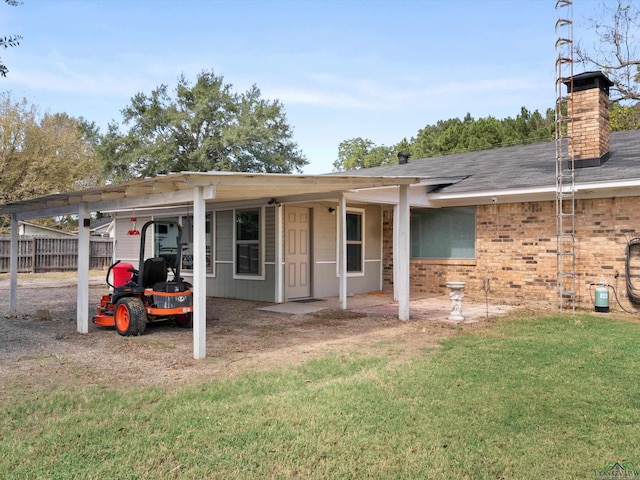 rear view of property featuring a yard