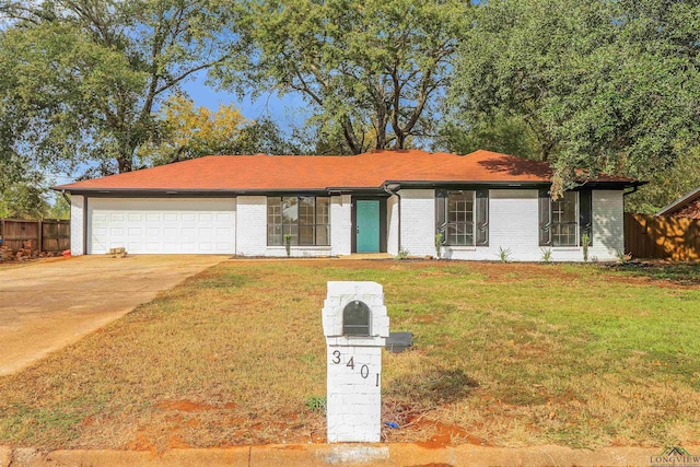 ranch-style home with a front yard and a garage