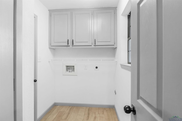 clothes washing area featuring cabinets, hookup for a washing machine, light wood-type flooring, and electric dryer hookup