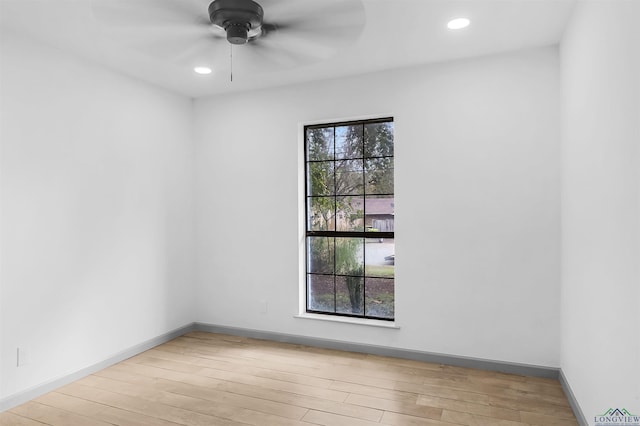 unfurnished room with ceiling fan and light wood-type flooring