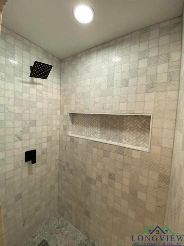 bathroom with a tile shower