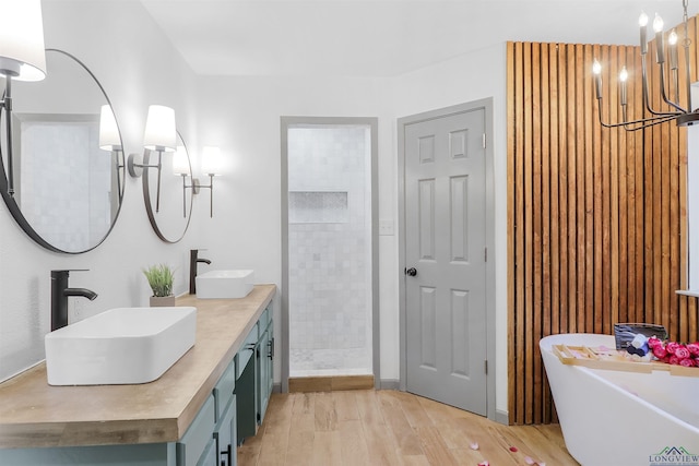 bathroom featuring hardwood / wood-style floors, vanity, and independent shower and bath