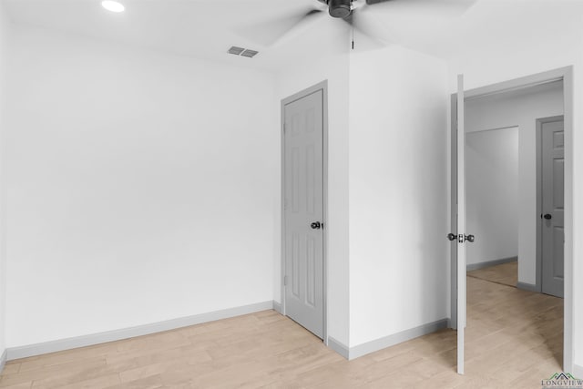 unfurnished bedroom with light wood-type flooring and ceiling fan