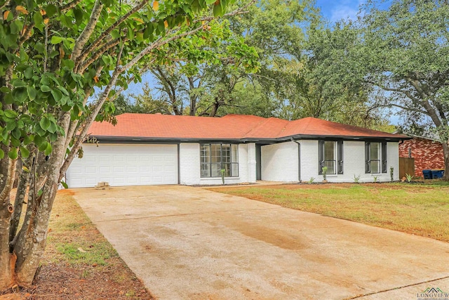 ranch-style house with a front yard and a garage