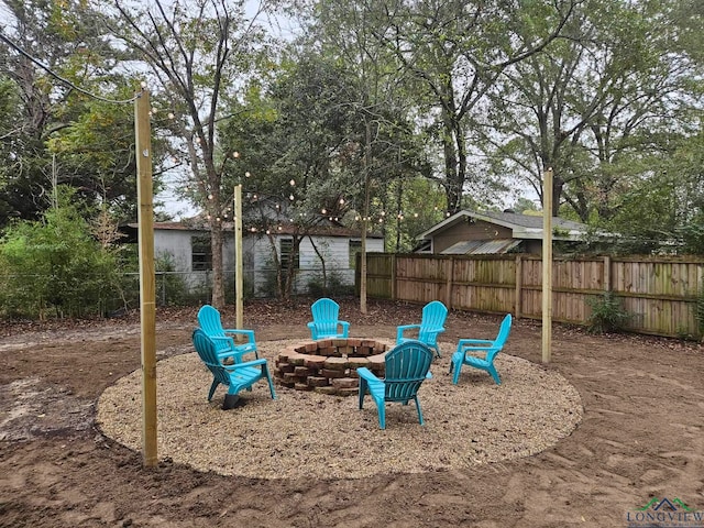 view of jungle gym featuring an outdoor fire pit