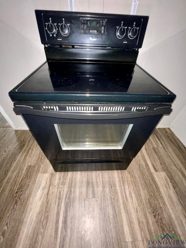 616 W Center St, White Oak, TX 75693 - kitchen view of black electric range, wood finished floors, and baseboards