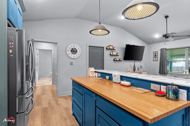 3315 N US Highway 259, Kilgore, TX 75662 - kitchen with stainless steel fridge with ice dispenser, wood counters, blue cabinetry, vaulted ceiling, and ceiling fan