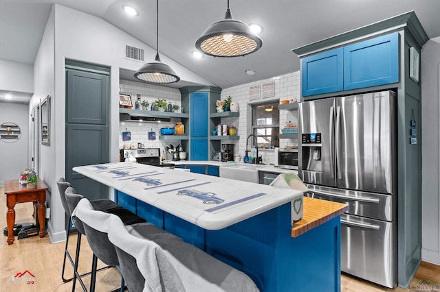 3315 N US Highway 259, Kilgore, TX 75662 - kitchen featuring stainless steel appliances, a sink, open shelves, blue cabinets, and a kitchen island