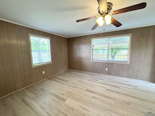1506 Scenic Dr, Longview, TX 75604 - unfurnished room featuring light wood-type flooring, a ceiling fan, wooden walls, and ornamental molding