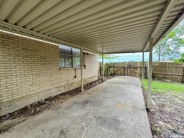 view of patio with fence and an attached carport
