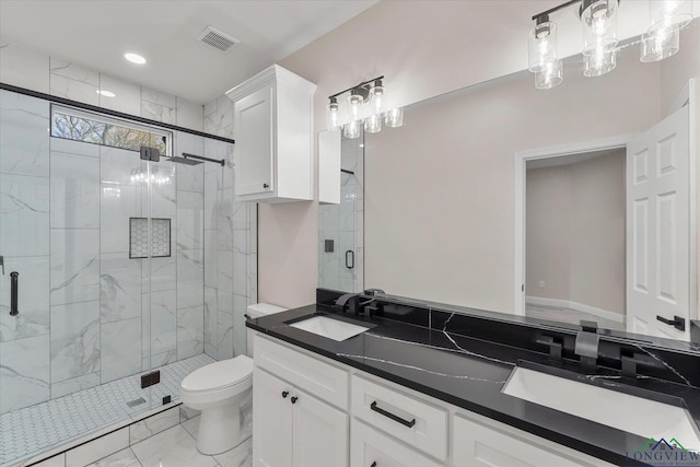 bathroom with vanity, toilet, and a shower with door