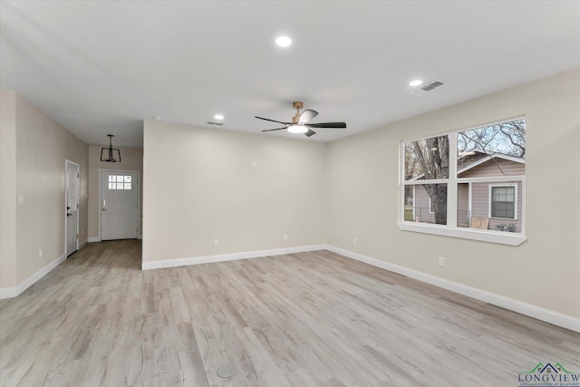 unfurnished room featuring ceiling fan, light hardwood / wood-style floors, and a healthy amount of sunlight