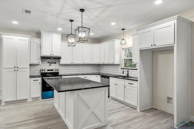 kitchen featuring white cabinetry, stainless steel appliances, sink, and hanging light fixtures