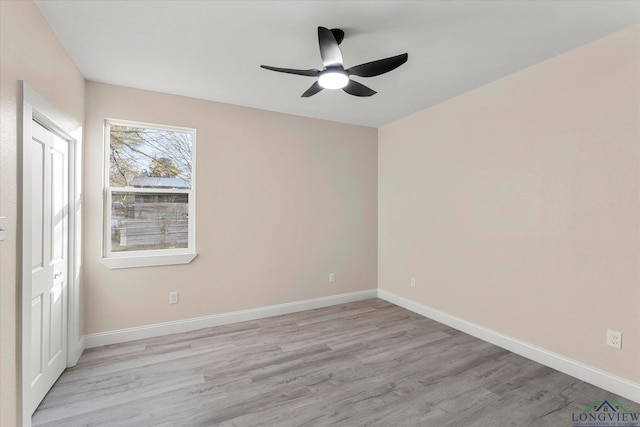 empty room featuring ceiling fan and light wood-type flooring