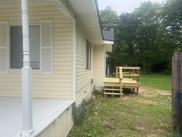 1609 Bomar St, Marshall, TX 75670 - view of property exterior with a wooden deck, a lawn, and roof with shingles