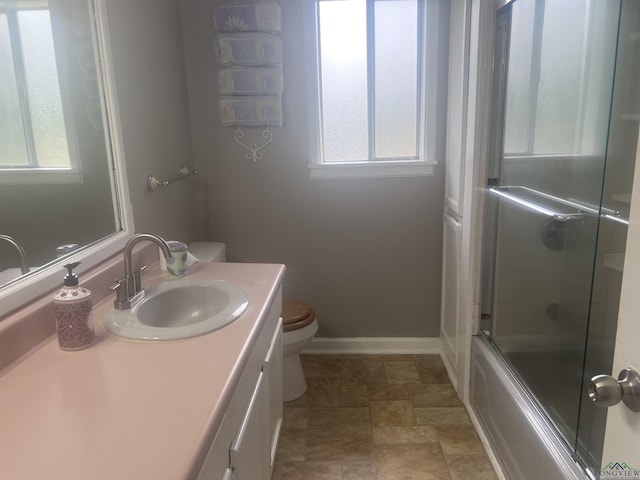 1609 Bomar St, Marshall, TX 75670 - full bathroom featuring healthy amount of natural light, stone finish floors, toilet, and vanity