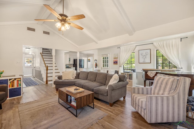 10887 Knollwood Dr, Tyler, TX 75703 - living area with beam ceiling, wood finished floors, stairs, ceiling fan, and high vaulted ceiling