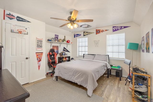 10887 Knollwood Dr, Tyler, TX 75703 - bedroom with light wood-type flooring, a ceiling fan, baseboards, and vaulted ceiling