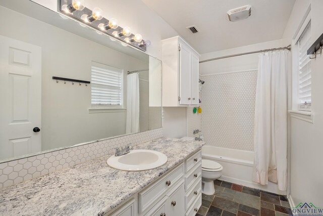10887 Knollwood Dr, Tyler, TX 75703 - full bathroom with vanity, shower / bathtub combination with curtain, toilet, and stone finish floors