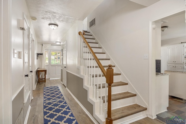 10887 Knollwood Dr, Tyler, TX 75703 - staircase with a textured ceiling