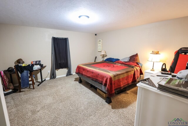 bedroom featuring carpet flooring and a textured ceiling