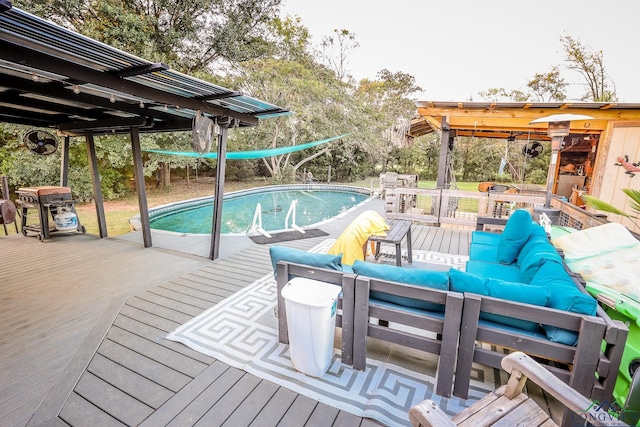 view of swimming pool featuring outdoor lounge area and a wooden deck