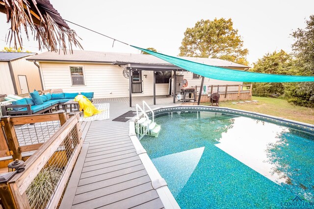 view of swimming pool featuring an outdoor hangout area and a deck