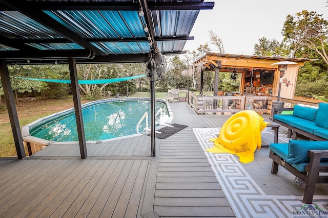 view of pool featuring a wooden deck and an outdoor living space