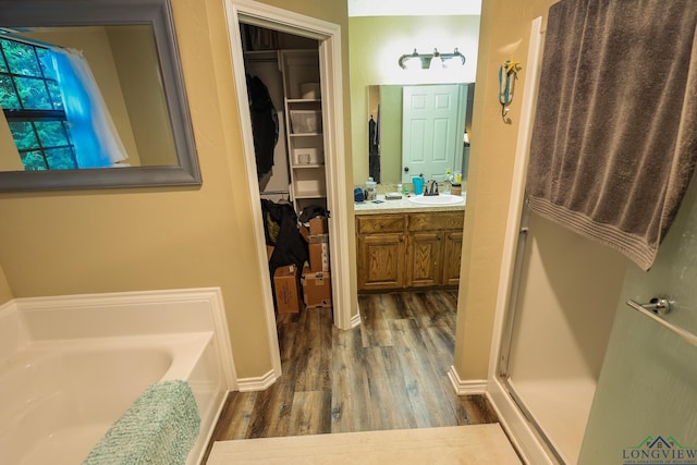 bathroom featuring vanity, hardwood / wood-style flooring, and a bathing tub