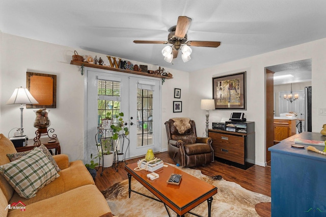 living area featuring baseboards, french doors, wood finished floors, and ceiling fan with notable chandelier