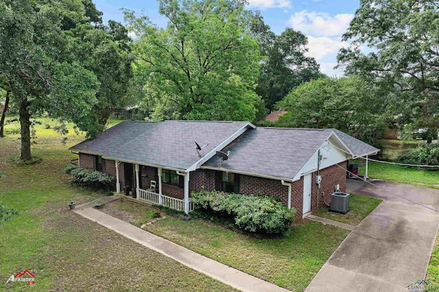 view of front of home featuring central AC unit, brick siding, a porch, and a front yard