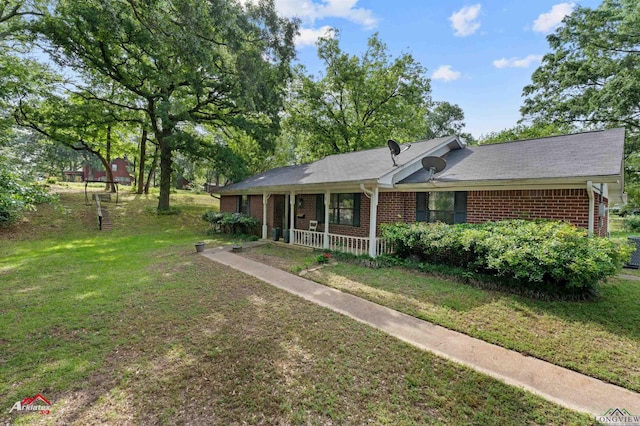 ranch-style house featuring brick siding, a porch, and a front lawn