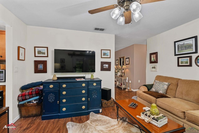 living room with visible vents, a ceiling fan, baseboards, and dark wood-style flooring