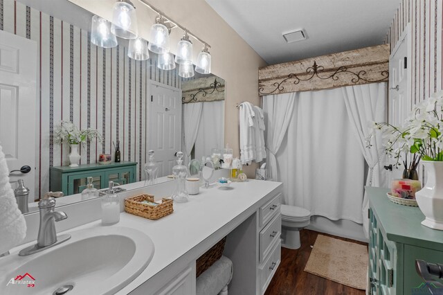 bathroom with visible vents, wood finished floors, vanity, and toilet