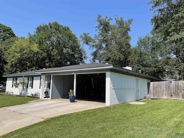 exterior space featuring a carport and a lawn