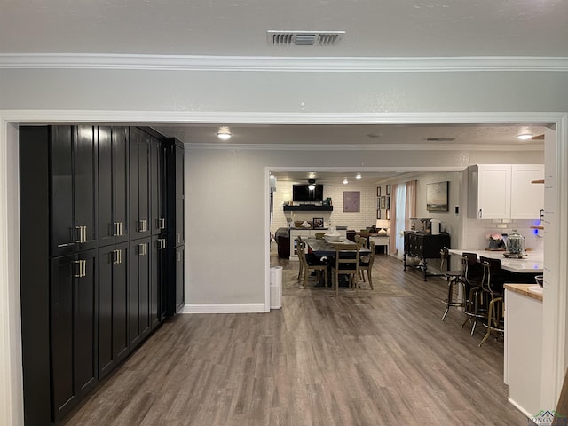 interior space featuring crown molding and hardwood / wood-style floors