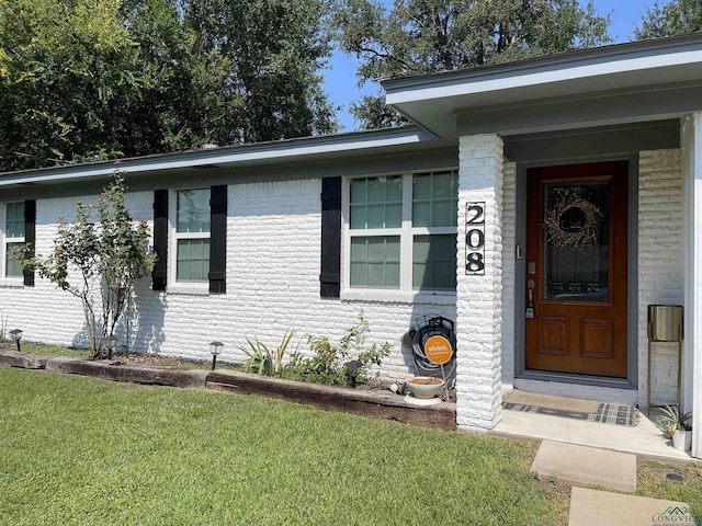 property entrance with a yard