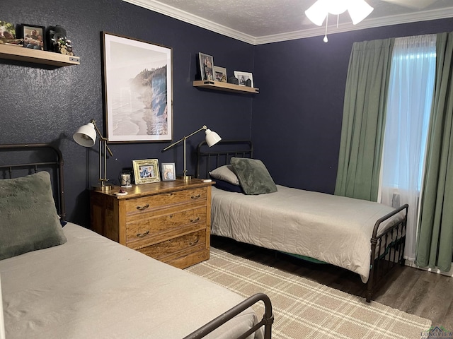 bedroom with a textured ceiling, ceiling fan, hardwood / wood-style flooring, and ornamental molding