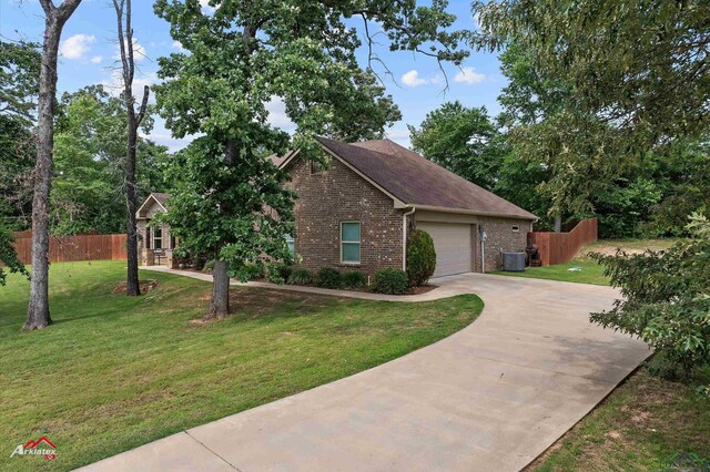 280 Towering Oaks Ln, Longview, TX 75602 - view of front of house with brick siding, driveway, a garage, central AC, and a shingled roof
