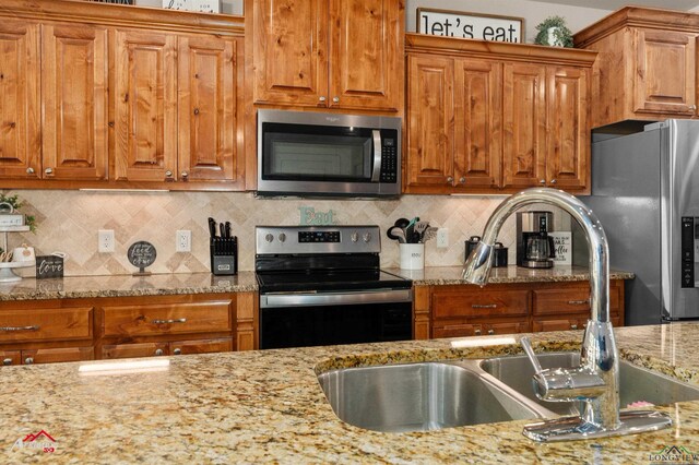 280 Towering Oaks Ln, Longview, TX 75602 - kitchen with appliances with stainless steel finishes and brown cabinets