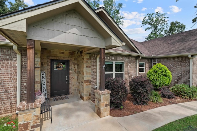 280 Towering Oaks Ln, Longview, TX 75602 - doorway to property with roof with shingles, brick siding, and stone siding