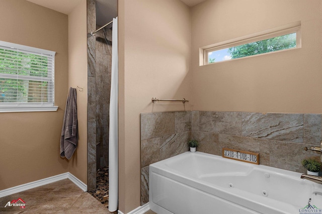 280 Towering Oaks Ln, Longview, TX 75602 - bathroom featuring a whirlpool tub, tiled shower, and baseboards